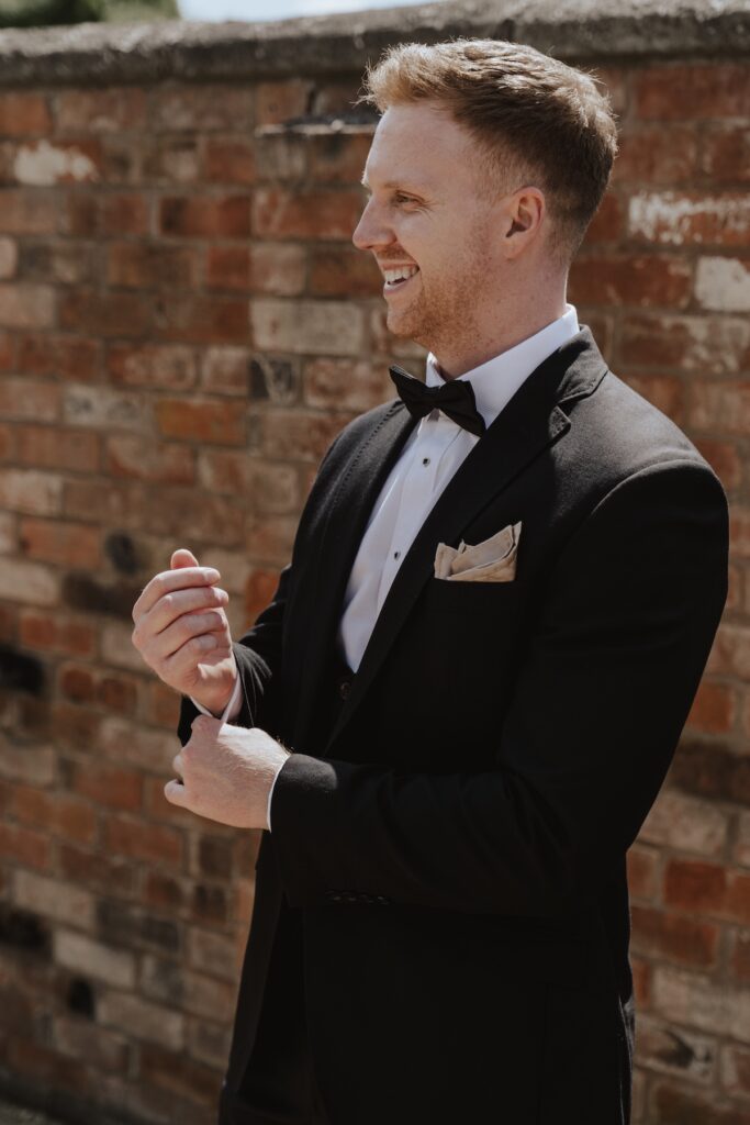The groom getting ready at Swallows Nest Barn in Warwick
