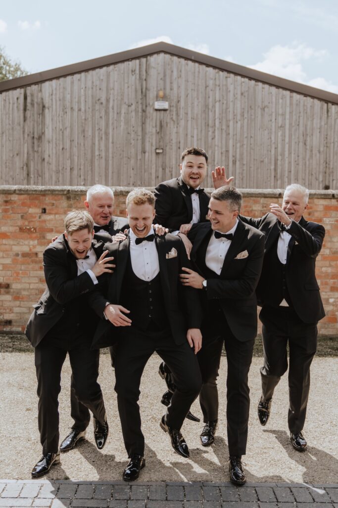 The groom and groomsmen during the morning of the wedding at Swallows Nest Barn