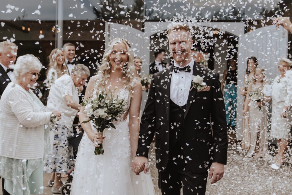 Northamptonshire wedding photographer capturing confetti at Swallows Nest Barn