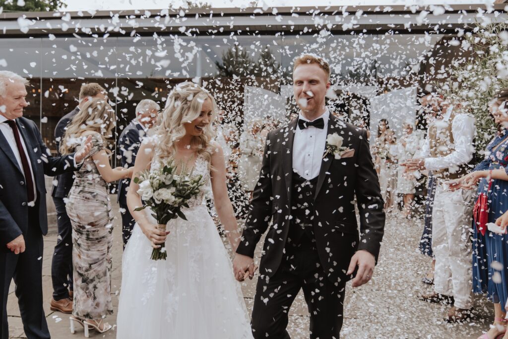 Swallows Nest Barn wedding photographer capturing confetti after the ceremony