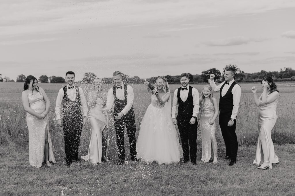 Northamptonshire wedding photographer capturing moments with bridesmaids and groomsmen at Swallows Nest Barn