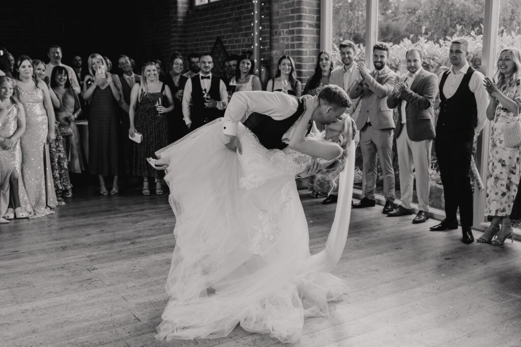 Warwick wedding photographer capturing a couple having their first dance at Swallows Nest Barn