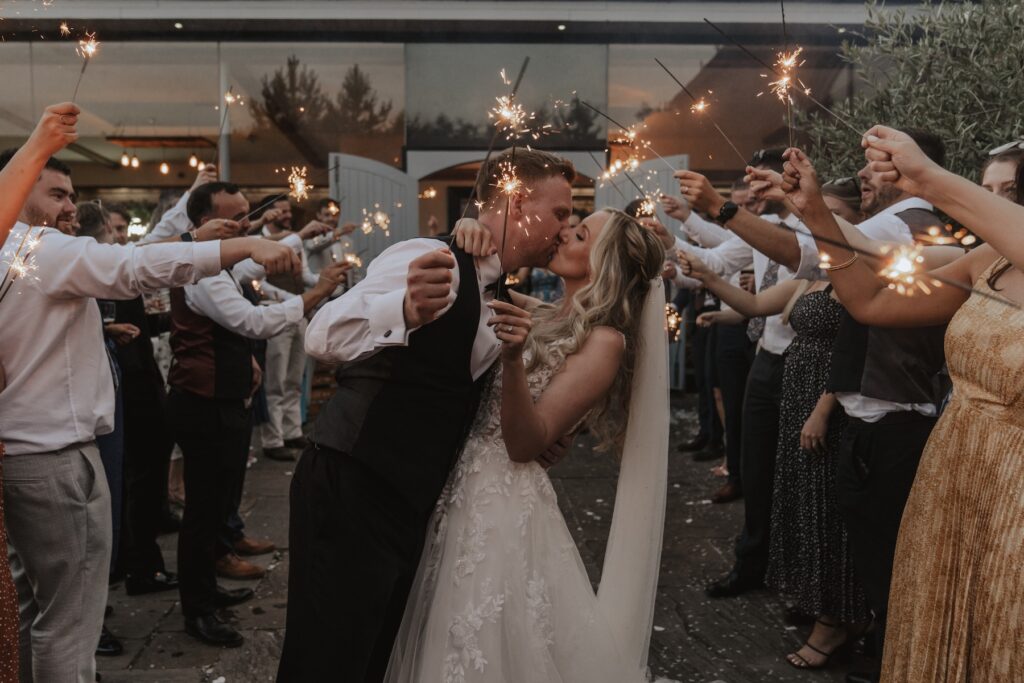 Northamptonshire wedding photographer capturing sparklers in the evening at Swallows Nest Barn in Northamptonshire