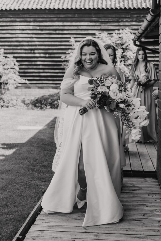 The bride walking to the ceremony barn at All Manor of Events in Suffolk