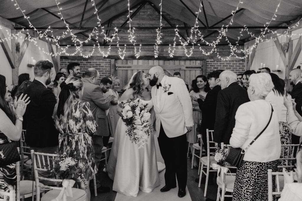 The couple walking down the aisle after their ceremony at All Manor of Events in Suffolk