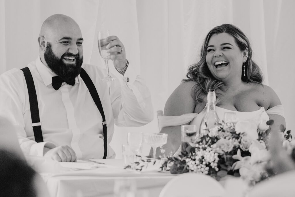 The couple during their speeches at their wedding at All Manor of Events in Suffolk