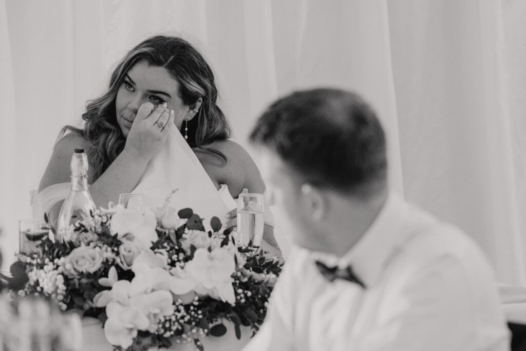 The bride getting emotional during speeches at their wedding at All Manor of Events in Suffolk