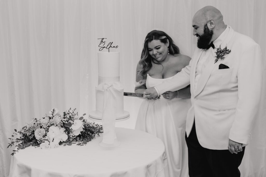The couple cutting their wedding cake at All Manor of Events in Suffolk