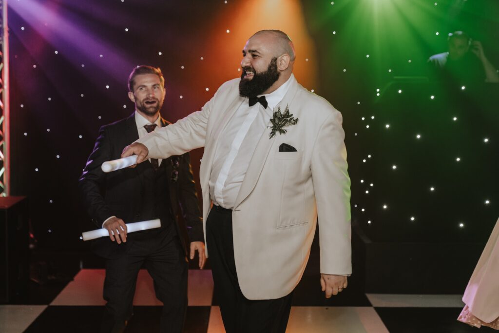 The groom dancing during the evening of his wedding at All Manor of Events in Suffolk