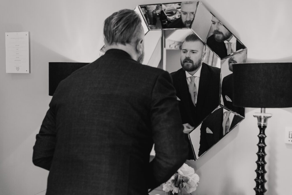 The groom getting ready at Bassmead Manor Barns