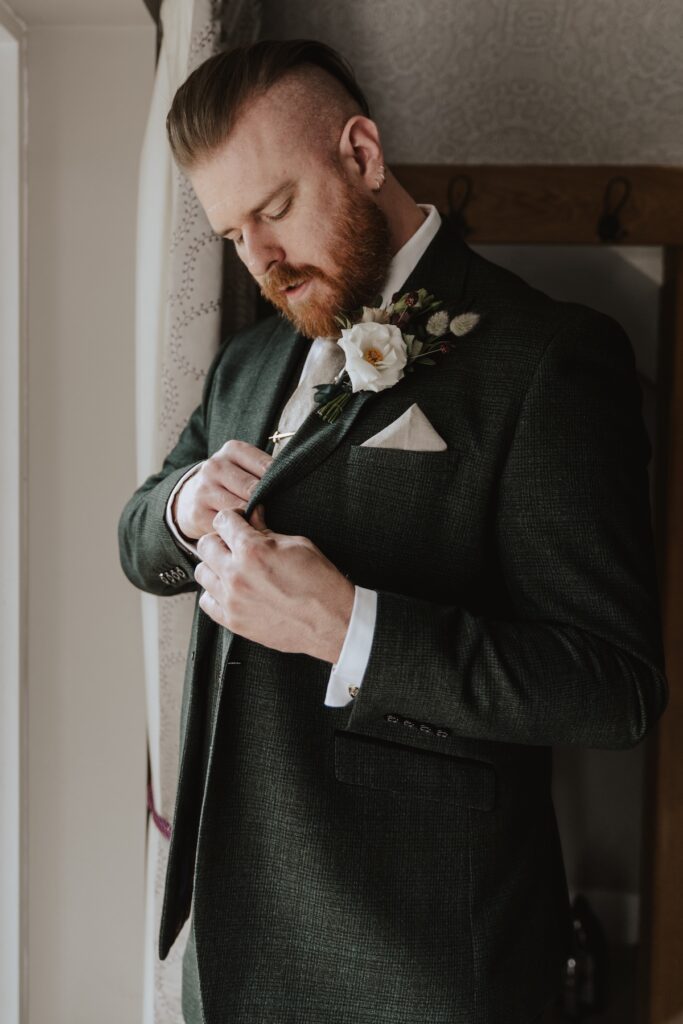 The groom getting ready at Bassmead Manor Barns in Cambridgeshire