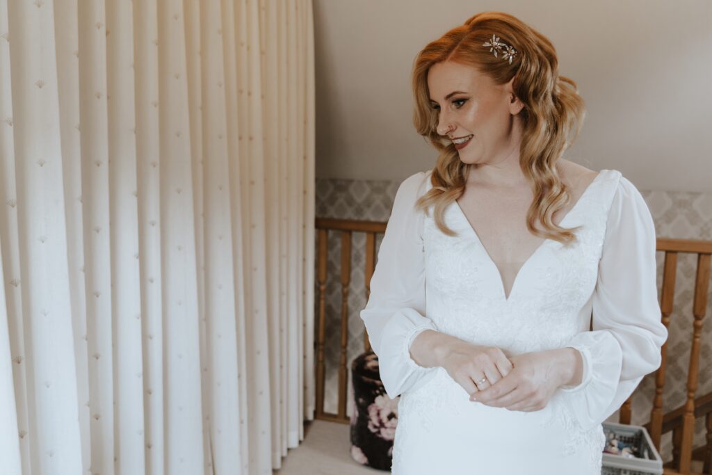 The bride getting ready in the bridal suite at Bassmead Manor Barns in Cambridgeshire
