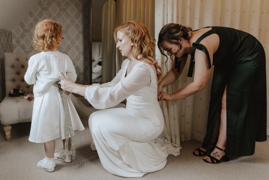 The bride getting ready with her bridesmaids at Bassmead Manor Barns in Cambridgeshire