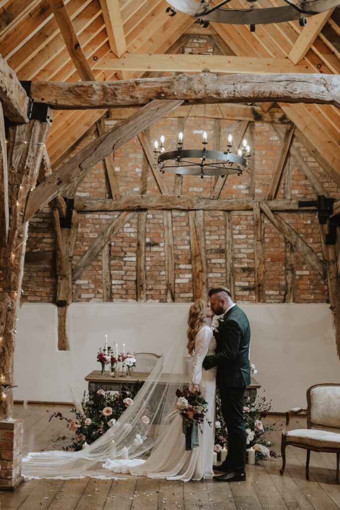 Cambridgeshire wedding photographer capturing the couple inside the ceremony barn at Bassmead Manor Barns