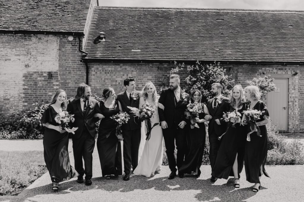 Cambridge wedding photographer capturing fun bridesmaids and groomsmen formal photos on the wedding at Bassmead Manor Barns in St Neots
