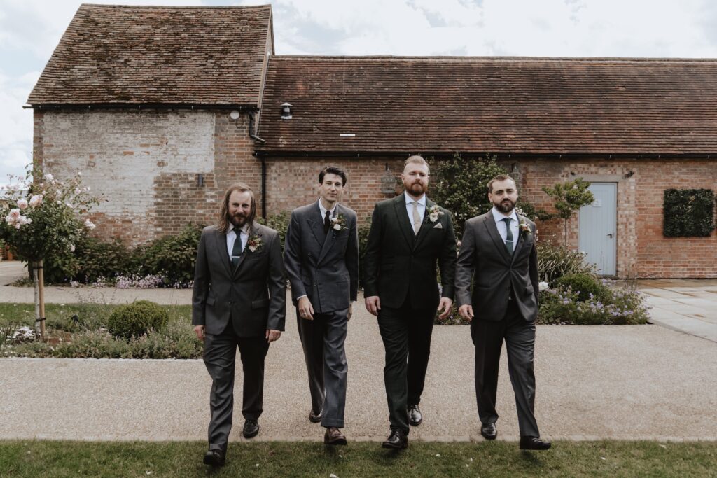 Fun groomsmen photo ideas at Bassmead Manor Barns in Cambridgeshire