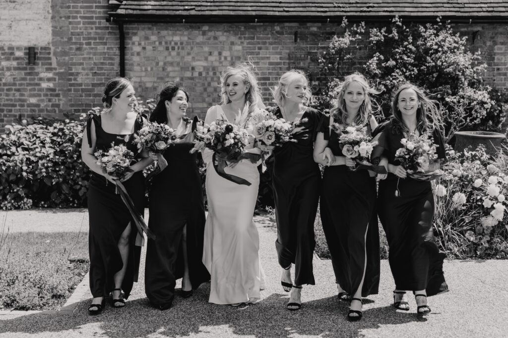Relaxed and fun bridesmaids photos on a wedding day at Bassmead Manor Barns in Cambridge