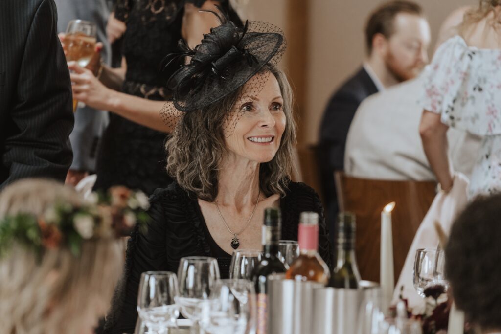 Wedding candids of guests during speeches at Bassmead Manor Barns in St Neots, Cambridge