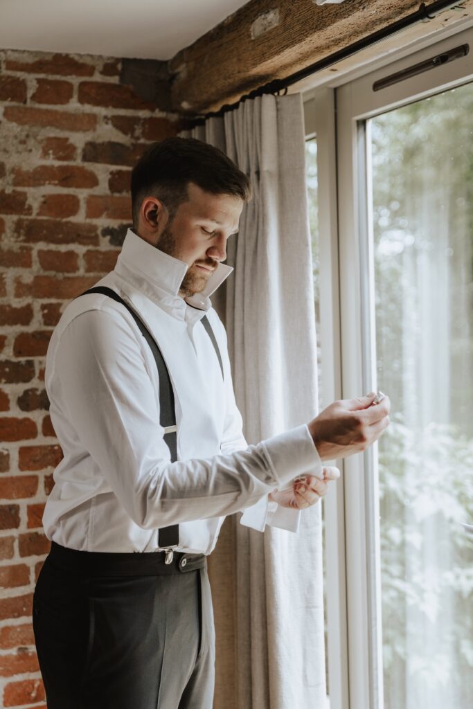 Suffolk wedding photographer capturing grooms prep at Easton Grange