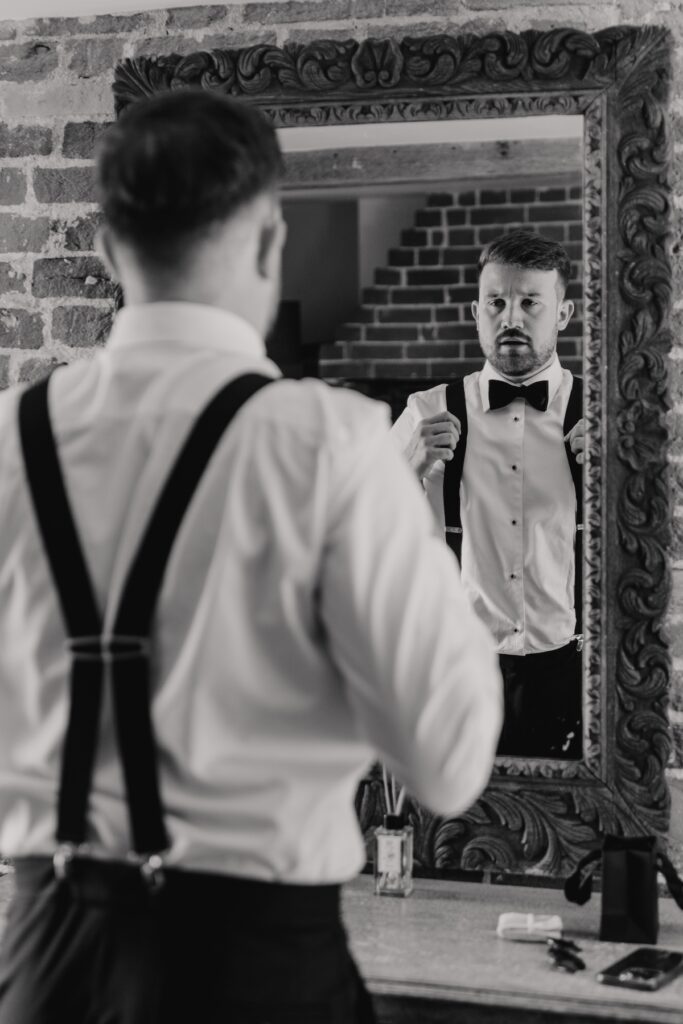 Wedding photographer in Suffolk capturing the groom getting ready at Easton Grange in Suffolk
