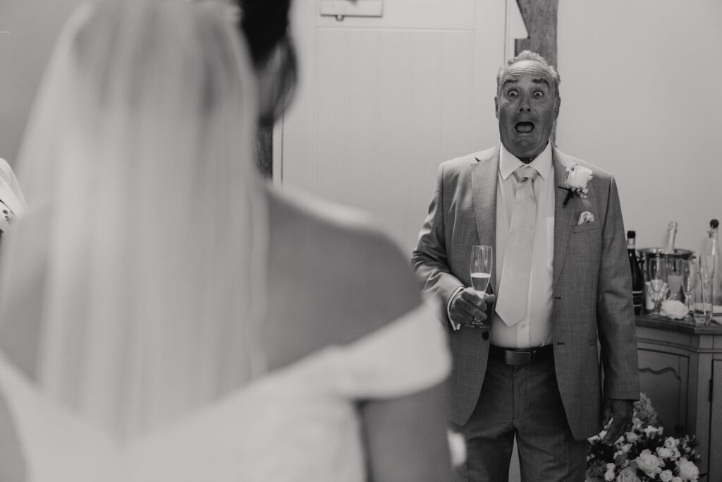 The bride having a first look with her father in the brdial suite at Suffolk wedding venue Easton Grange
