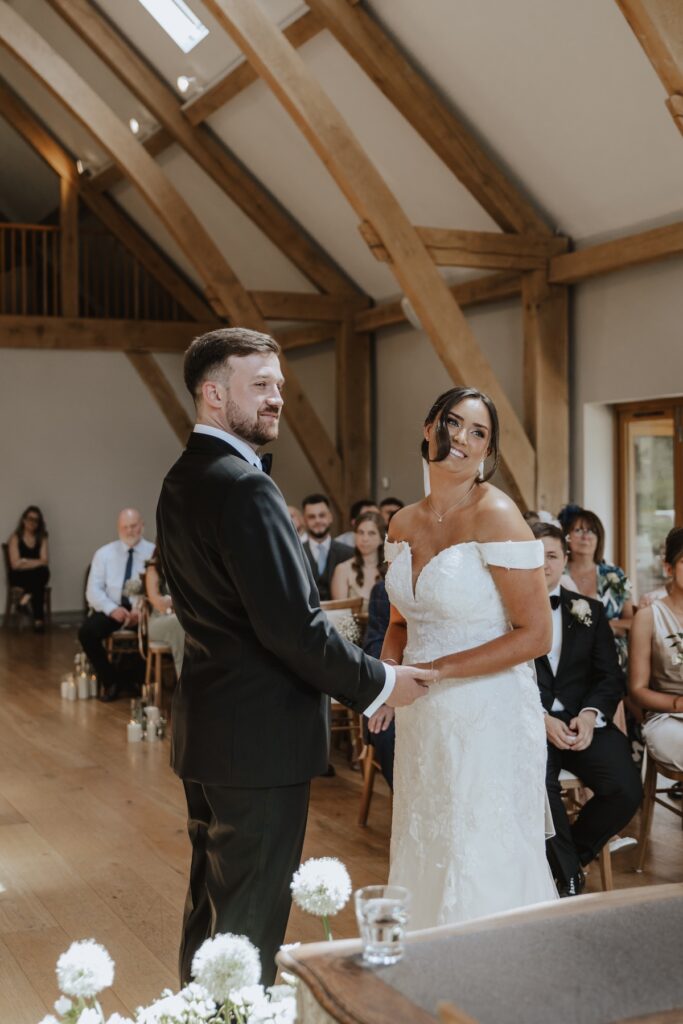 Easton Grange wedding in Suffolk during the ceremony at the ceremony barn in Suffolk