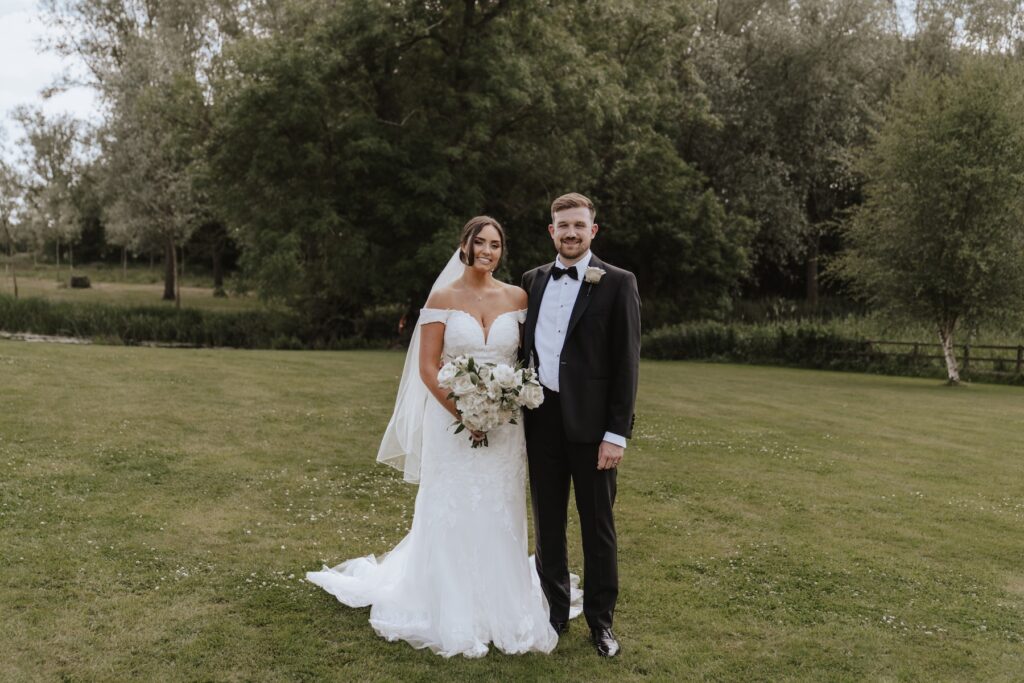 Suffolk wedding photographer capturing formal photos with the couple at Easton Grange