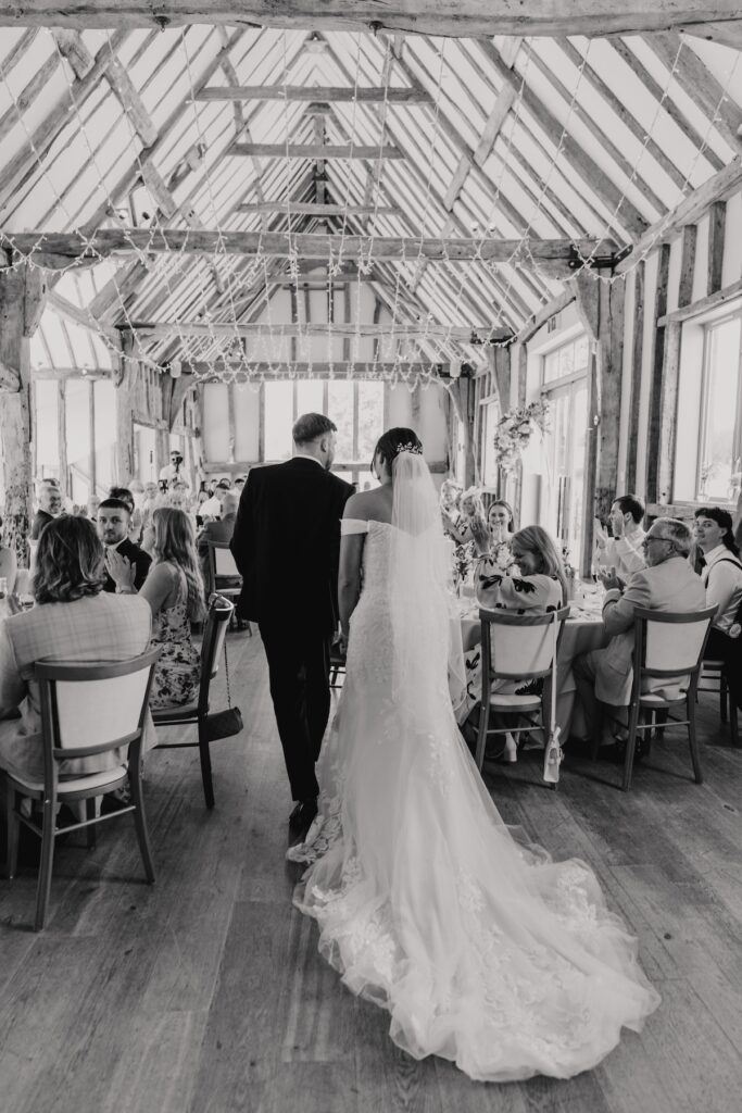 The couple walking into their wedding meal at Easton Grange in Suffolk