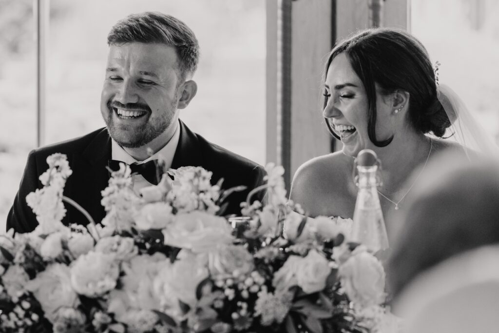 Candids of a newlywed couple during speeches at Easton Grange in Suffolk
