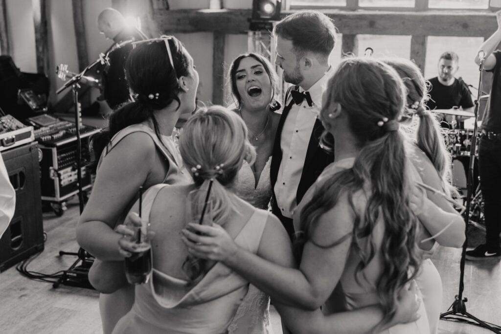 The bride dancing with her bridesmaids on the dance floor at Easton Grange during a Suffolk wedding