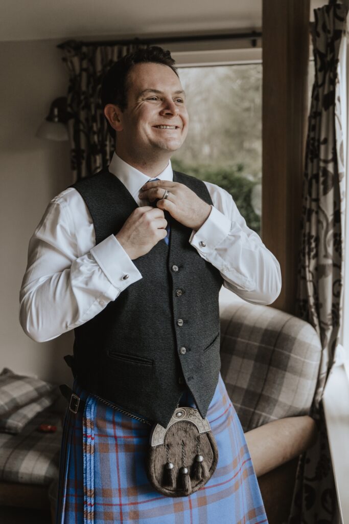 Grooms prep at the Cairngorms during a Scotland elopement