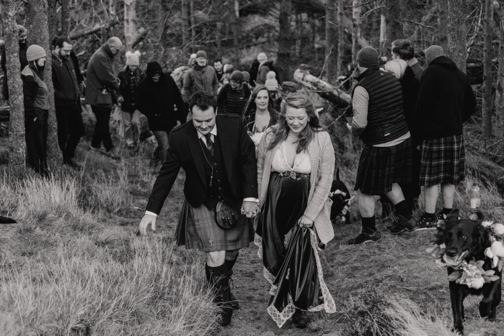 An eloping couple in Scotland arriving with their guests to their elopement spot in The Cairngorms