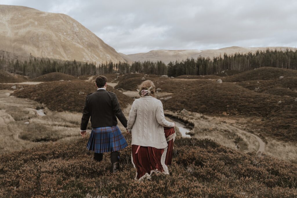 A couple exploring Corrie Fee during their Scottish elopement