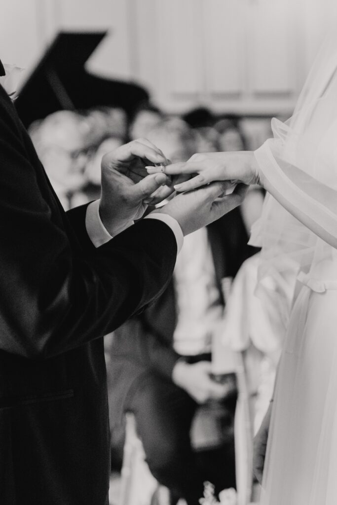 Essex wedding photographer capturing the ring exchange at Gosfield Hall