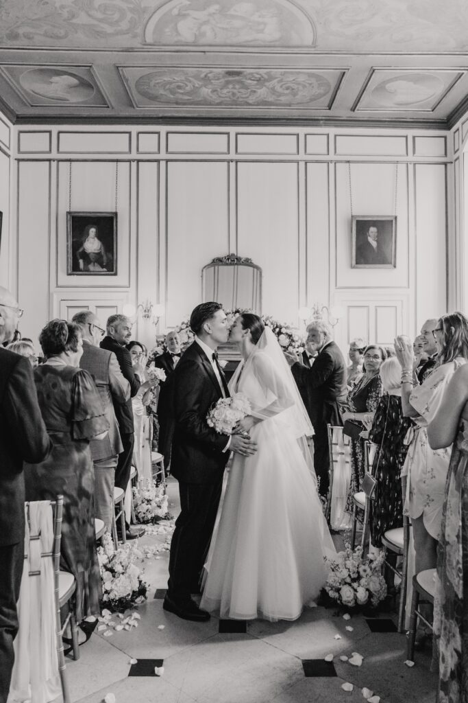 The newlyweds walking down the aisle together at Gosfield Hall