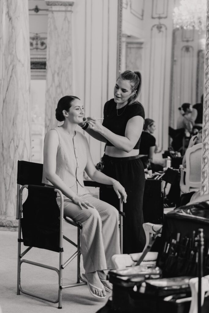 The bride getting her makeup done at the bridal suite at Gosfield Hall