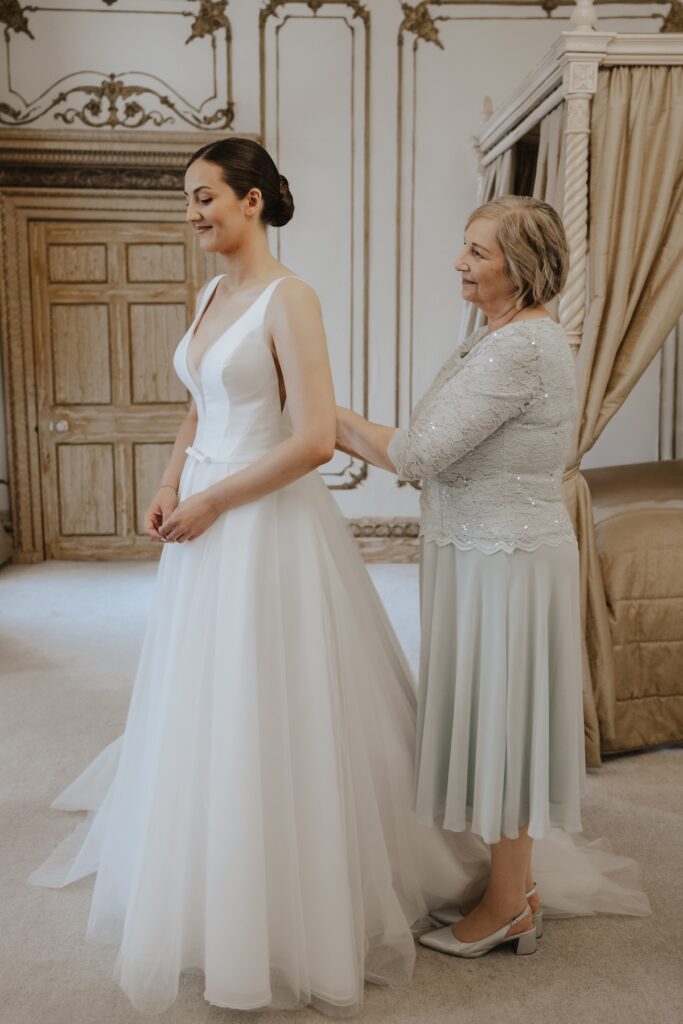 The bride getting her dress on at Gosfield Hall