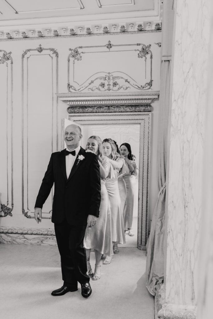 The bride's father bringing in the bridesmaids for a first look at Gosfield Hall