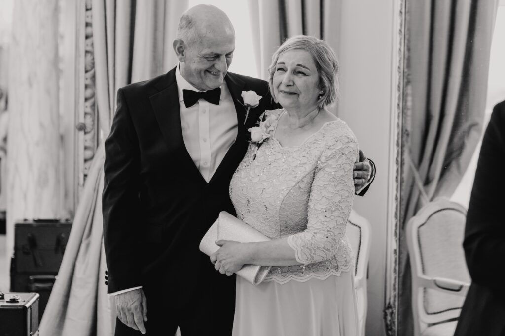 The bride's parents seeing their daughter for the first time on the morning of the wedding day at Gosfield Hall
