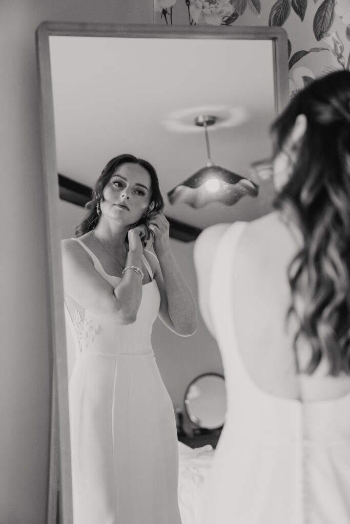The bride finishing getting ready in silk and maple gown, Suffolk wedding photographer captures moment