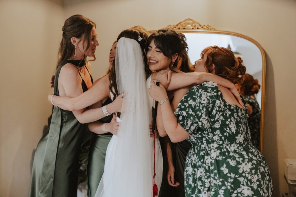 Chloe laughing with bridesmaids during bridal prep at Copdock Hall
