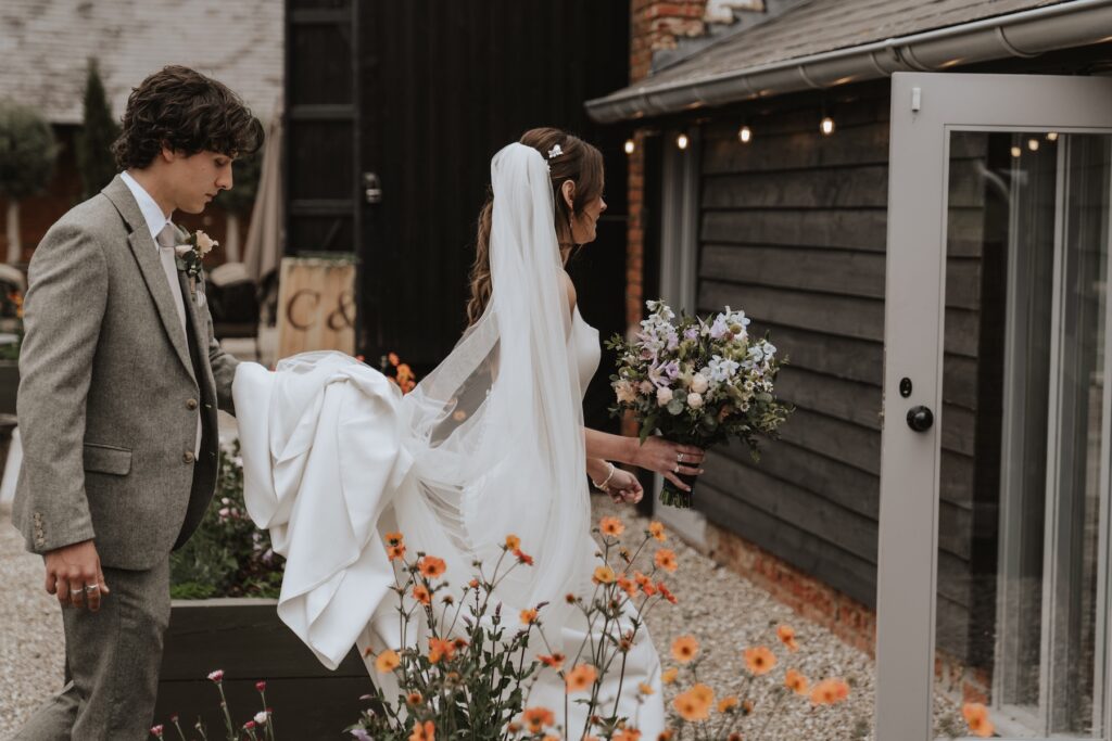 Bride walking from Copdock Hall accommodation to the ceremony