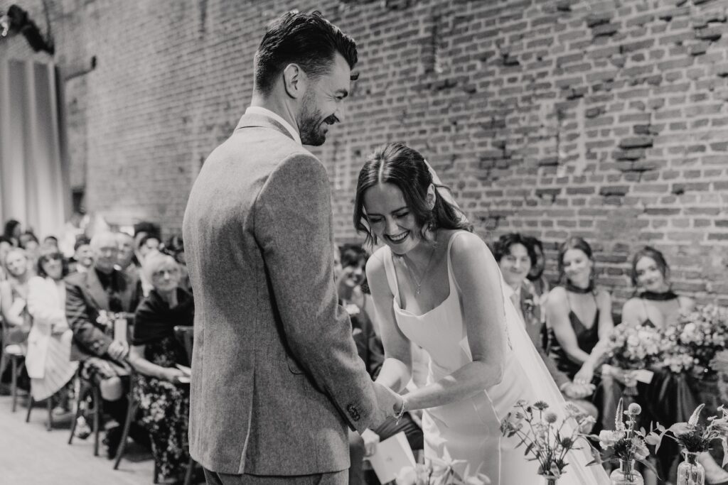 Couple exchanging vows inside Copdock Hall brick ceremony space, Suffolk wedding photographer