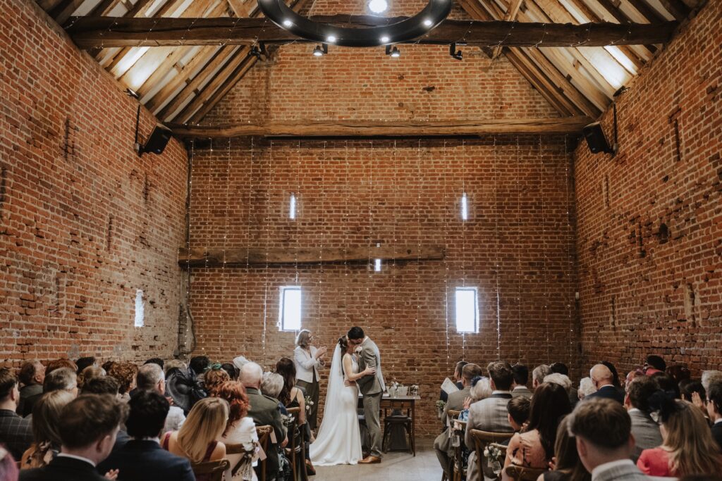 Guests watching emotional ceremony in Copdock Hall’s brick interior