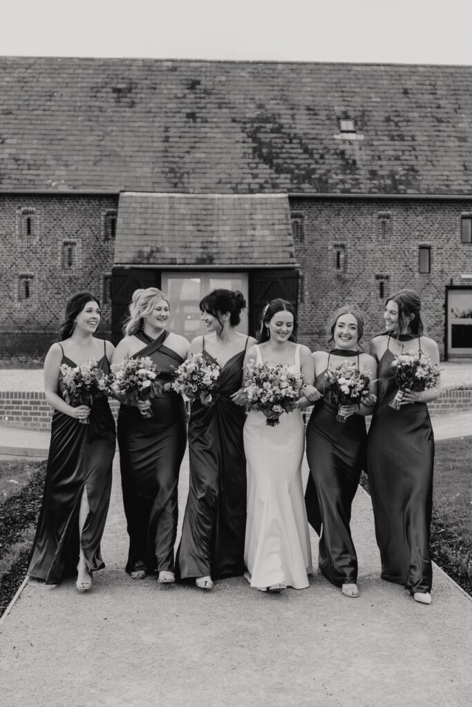 Bridesmaids laughing together during group photos at Copdock Hall wedding
