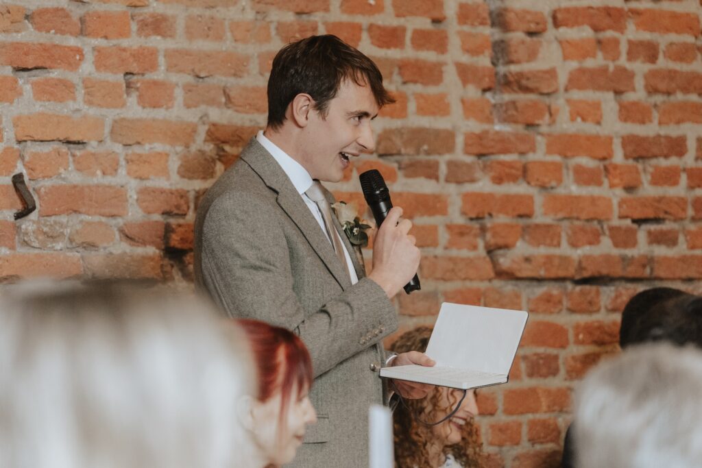 The groomsmen giving a speech in Copdock Hall