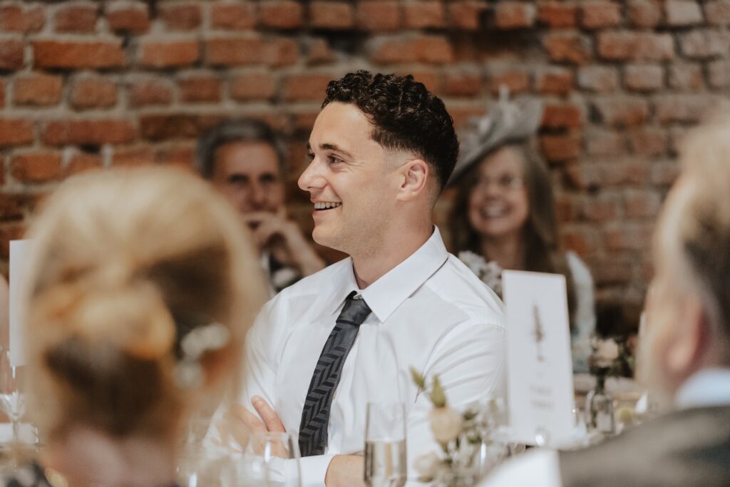 Copdock Hall wedding photographer capturing guest reactions to speeches in Suffolk