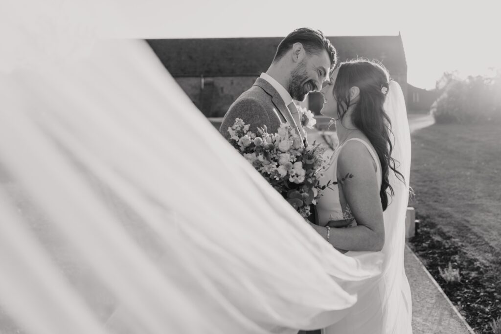 Golden light falling on couple during Copdock Hall wedding portraits