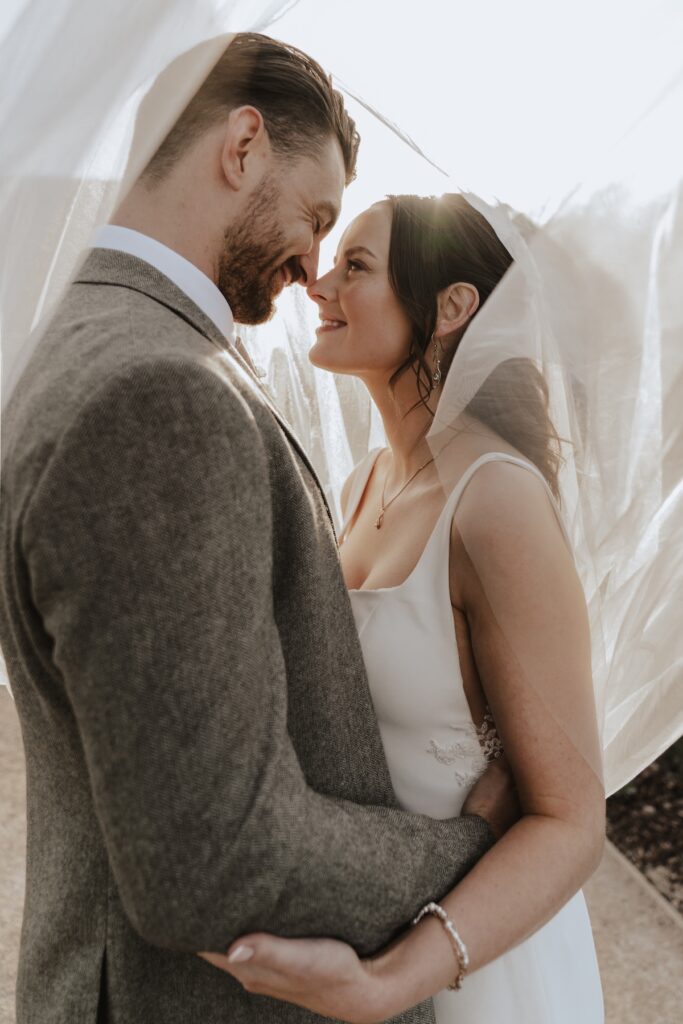 Couple sharing a quiet moment at sunset outside Copdock Hall Suffolk