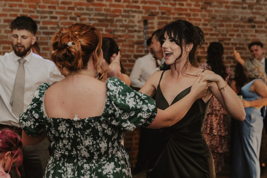 Candid moment of laughter on the dancefloor at Copdock Hall wedding